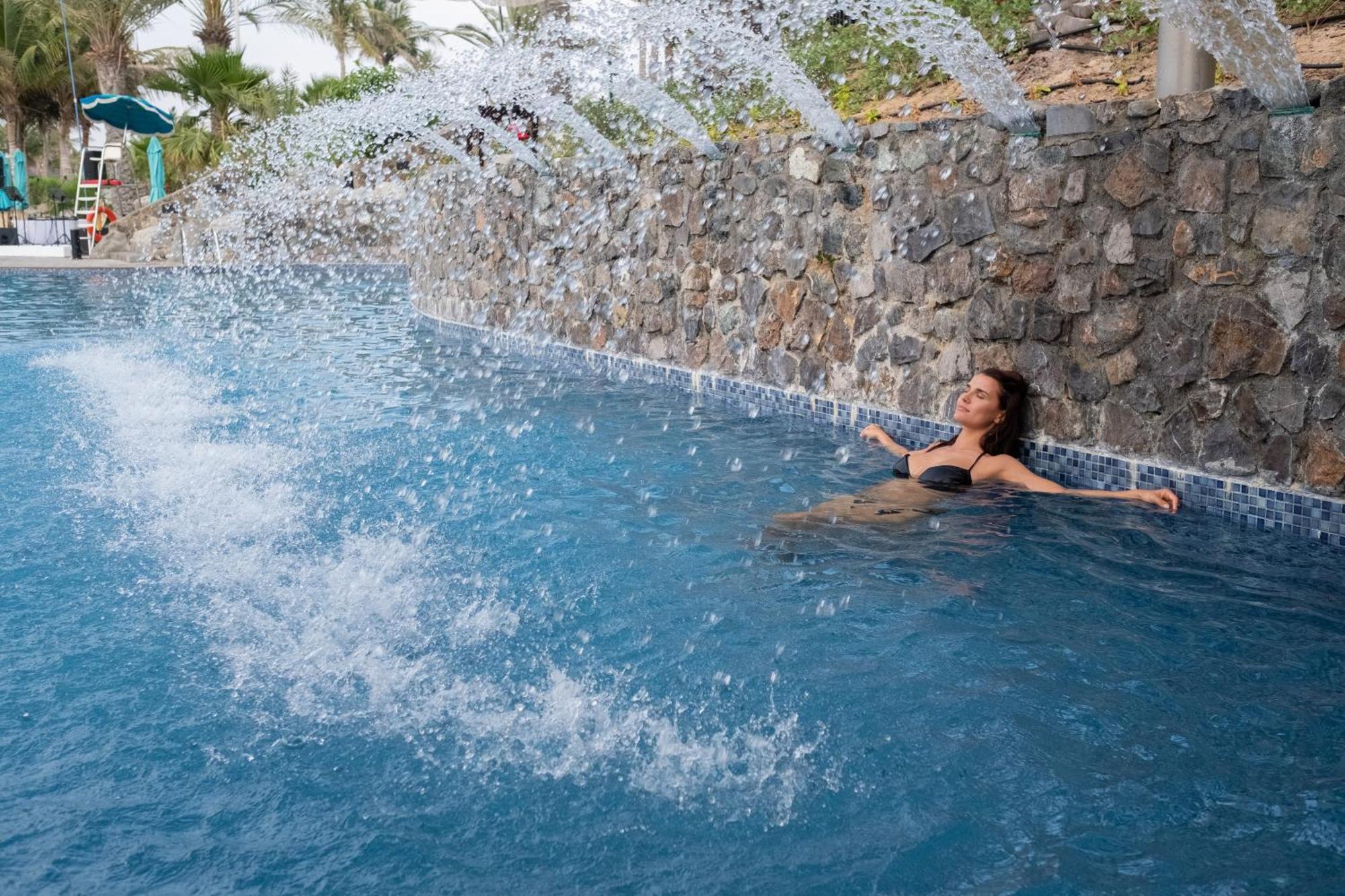 Ja The Resort - Ja Palm Tree Court, Dubái Exterior foto A woman relaxing in a swimming pool